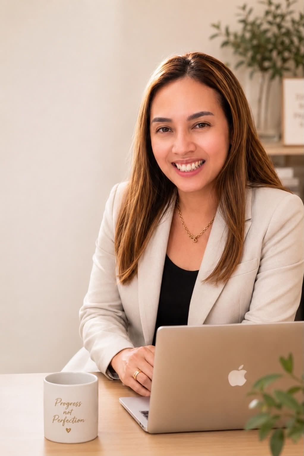 Ruth Abestilla, financial advisor with Sun Life Philippines, at her desk with a laptop