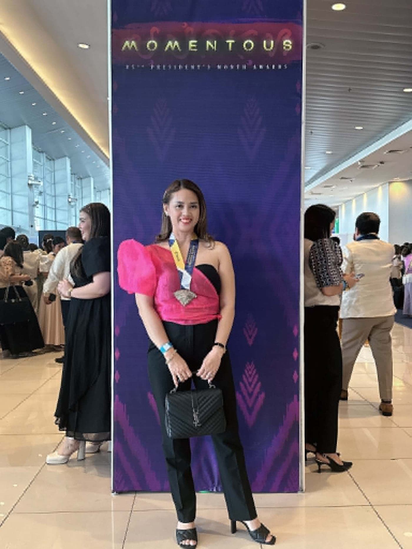 Ruth Abestilla at the Sun Life Momentous President's Award event wearing her medal
